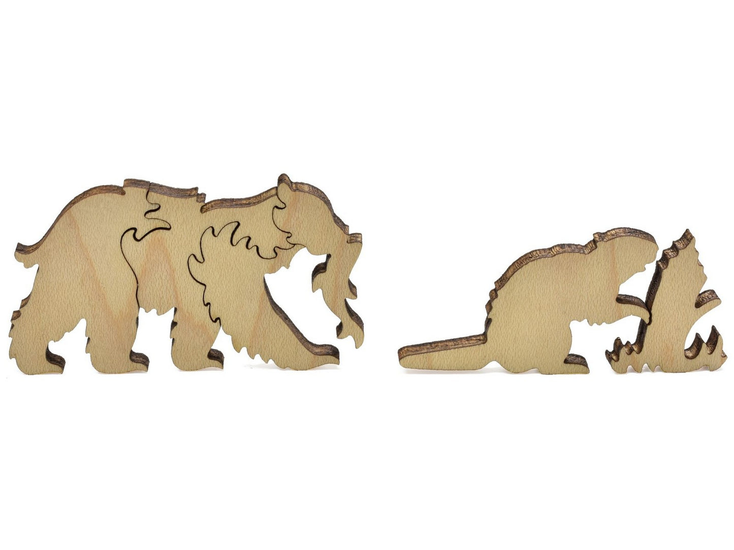 A closeup of pieces showing a bear with a salmon in its mouth and a beaver.