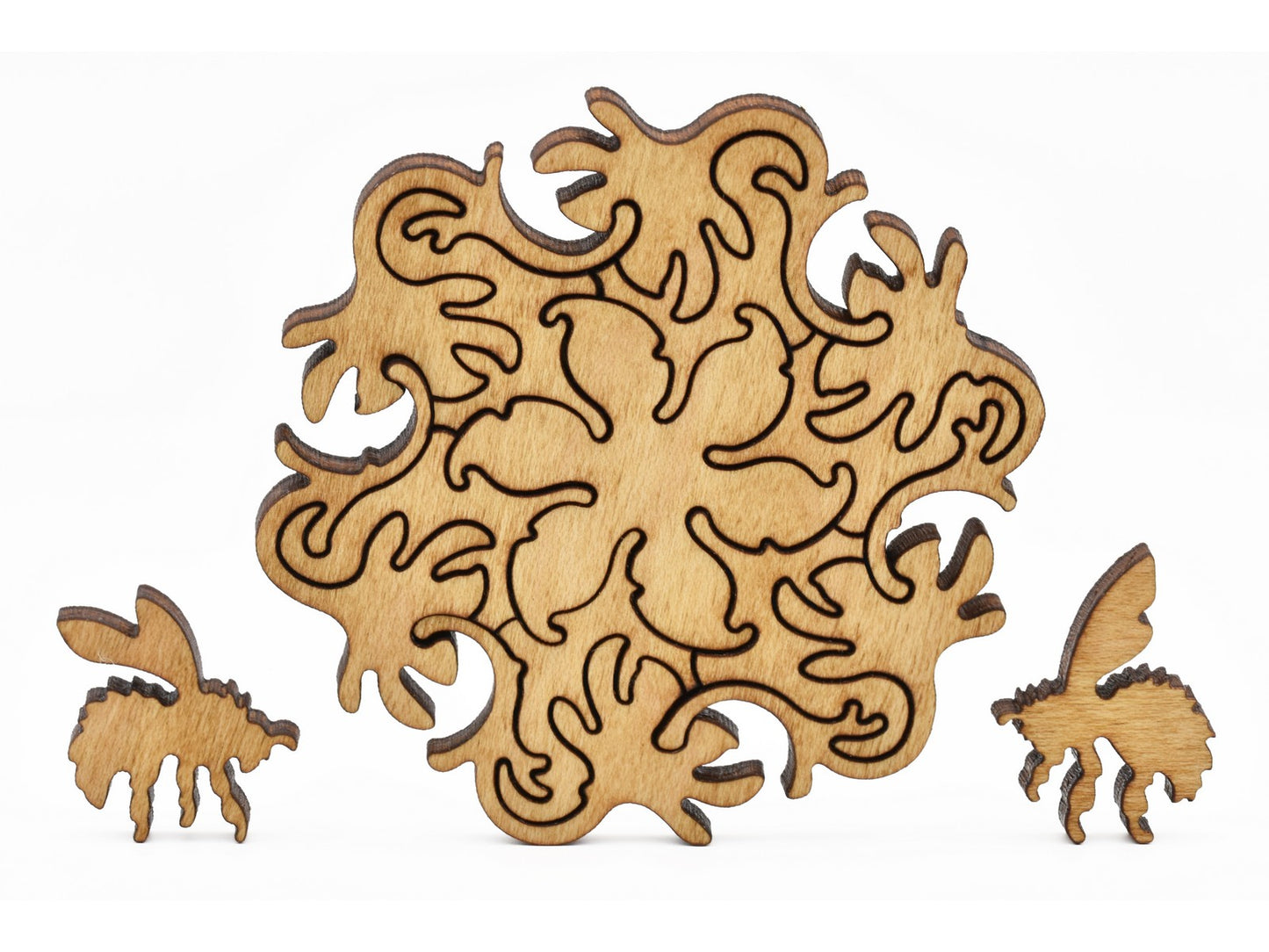 A closeup of pieces shaped like bees and flowers.