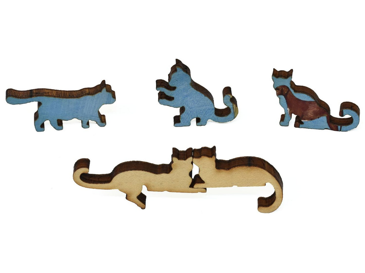 A closeup of pieces showing two cats cuddling and three kittens.