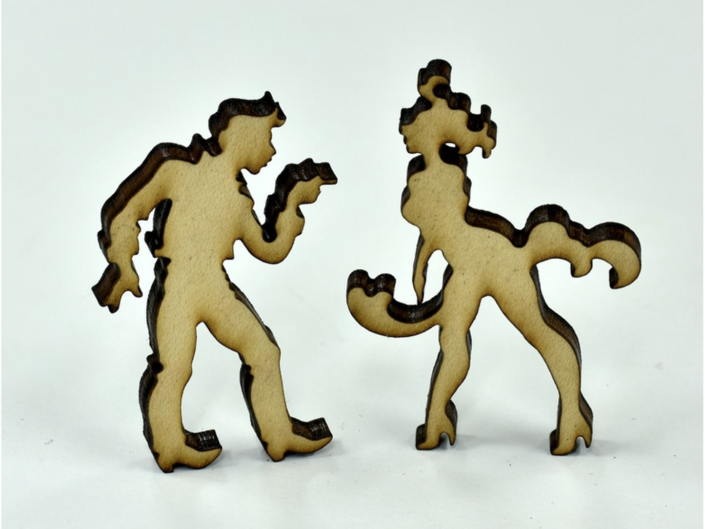 A closeup of pieces in the shape of two people dancing.