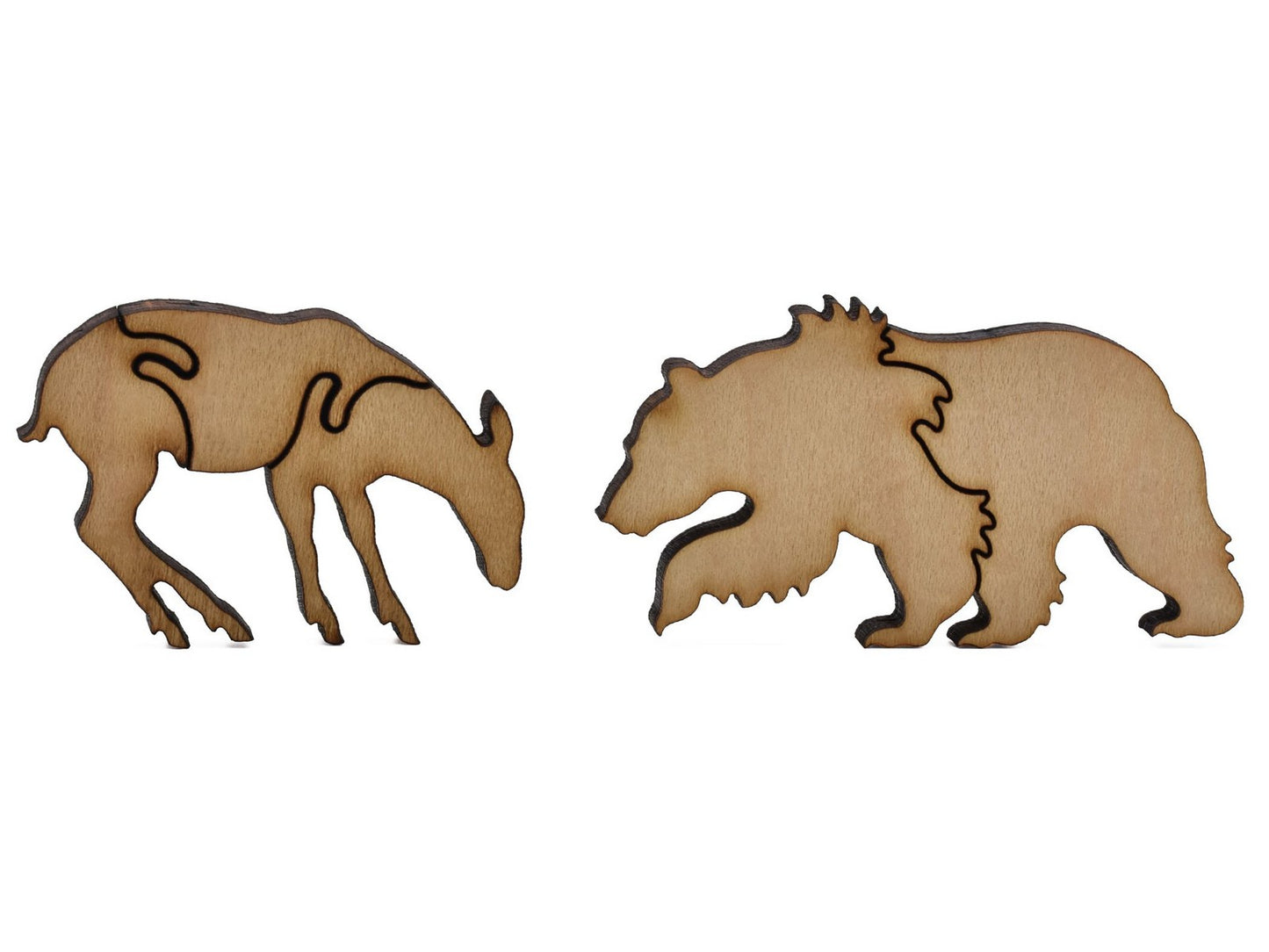 A closeup of pieces shaped like a deer and a bear.