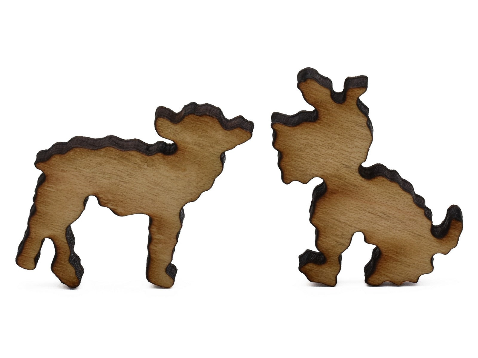 A closeup of pieces shaped like a lamb and a dog.