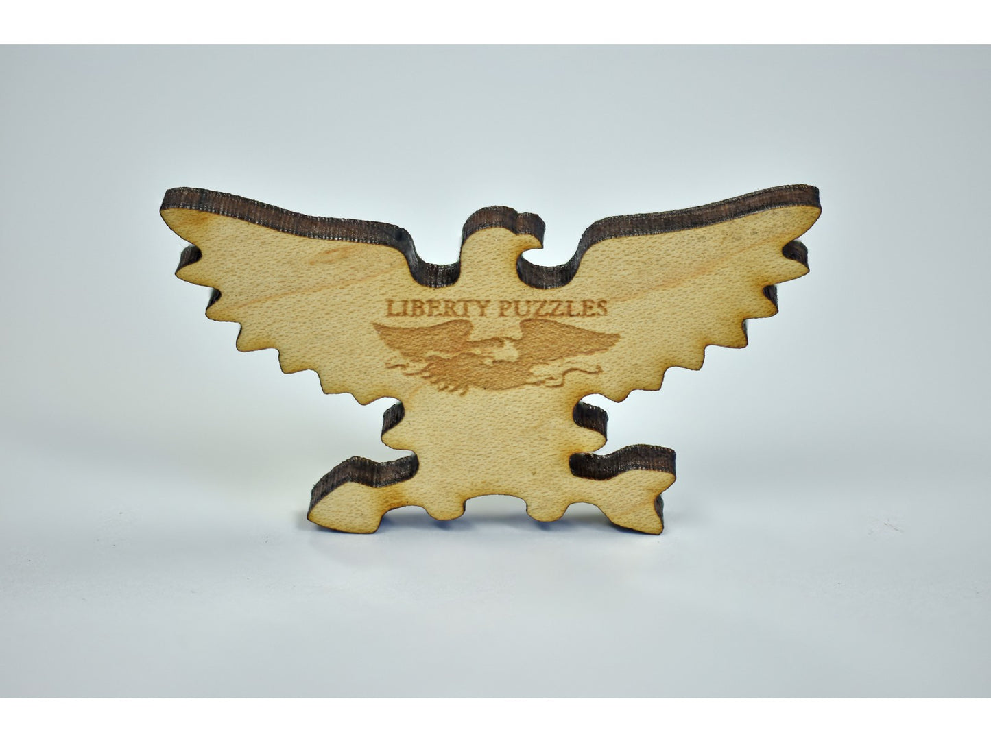 A closeup of a piece in the shape of an eagle.