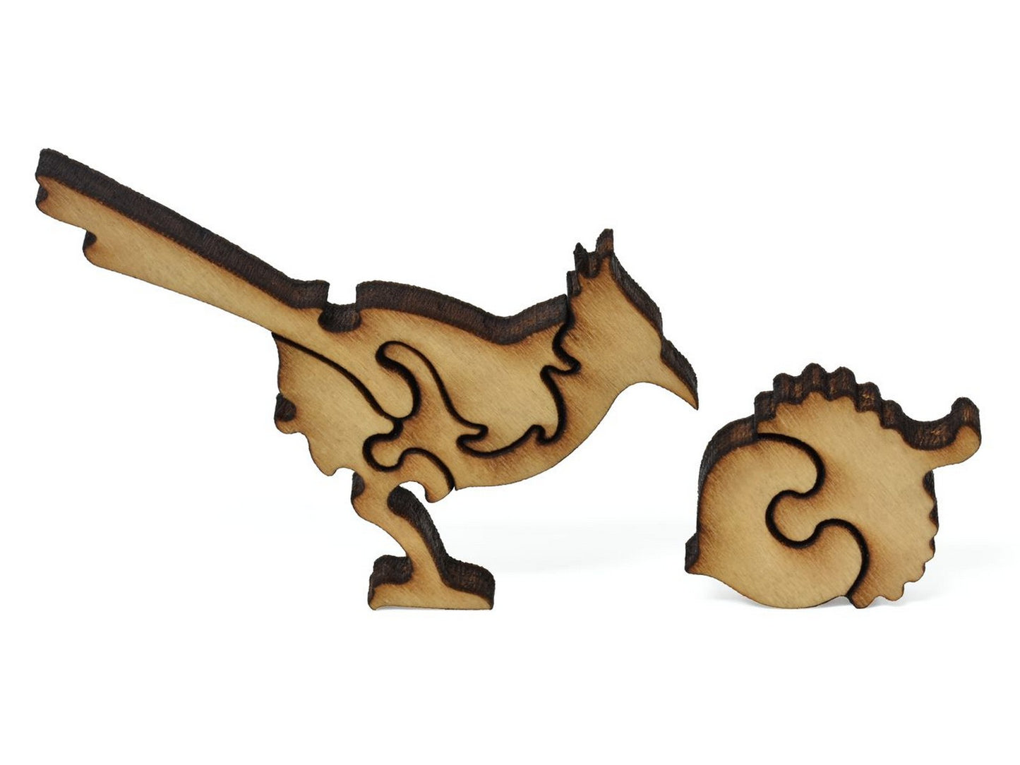 A closeup of pieces showing a blue jay and an acorn.