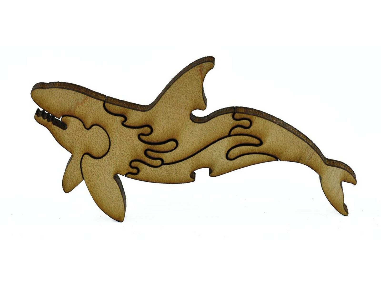 A closeup of pieces in the shape of an orca whale.