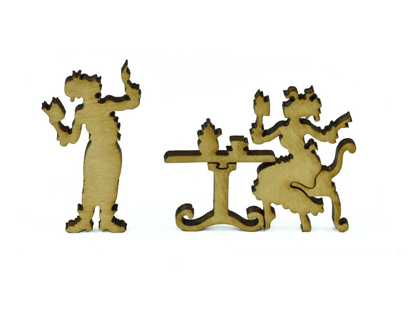 A closeup of pieces in the shape of two people relaxing at a table.