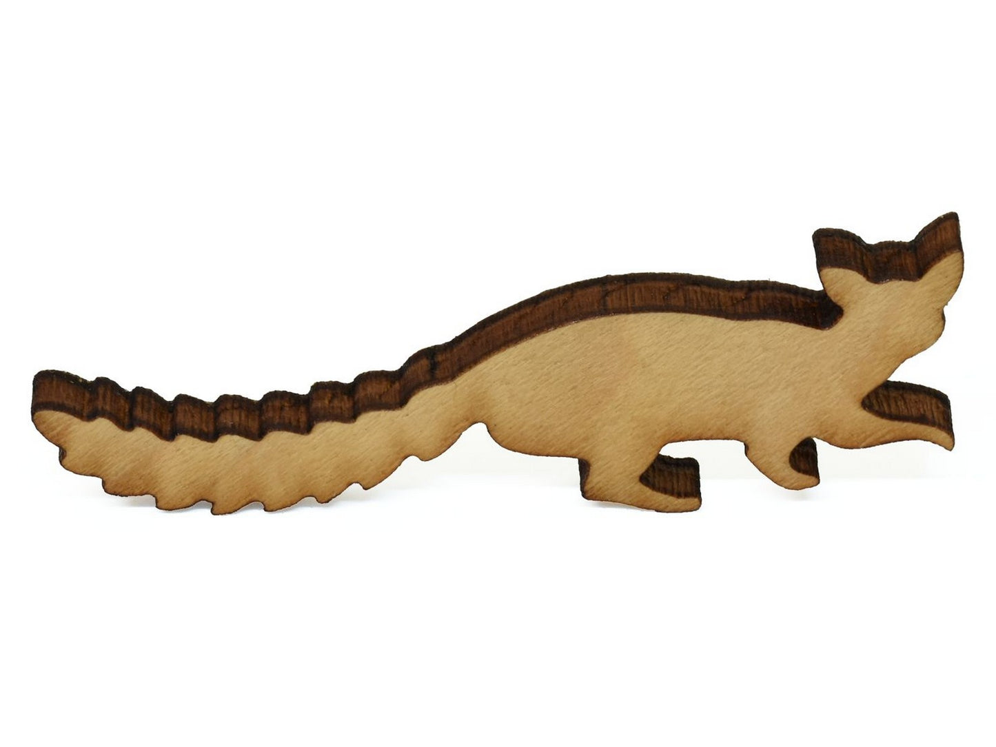 A closeup of a piece in the shape of the a ring tailed cat.