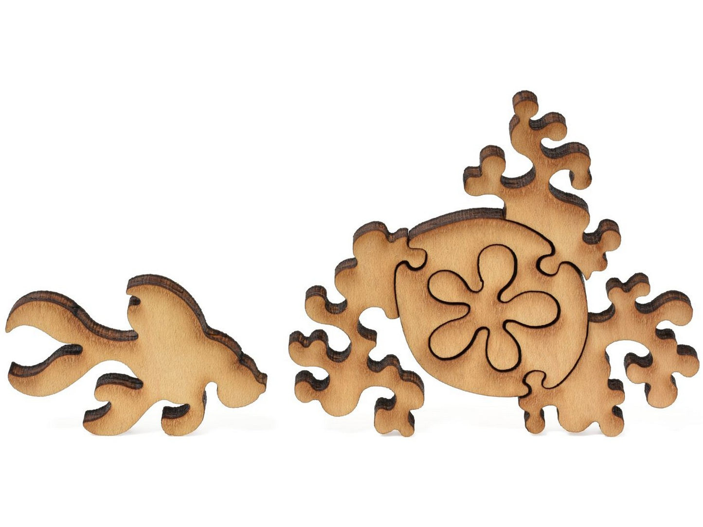 A closeup of pieces showing a fish and a sand dollar.