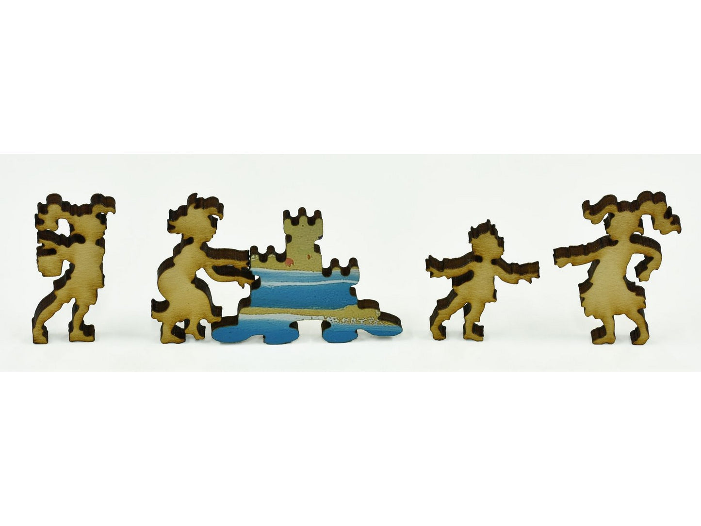 A closeup of pieces in the shape of children building a sand castle.