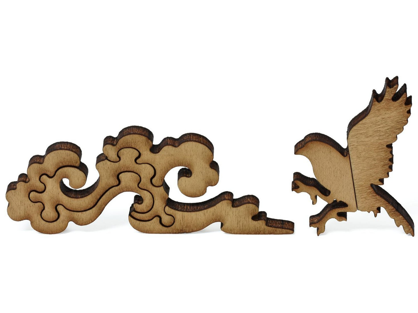 A closeup of pieces showing a bird and clouds.