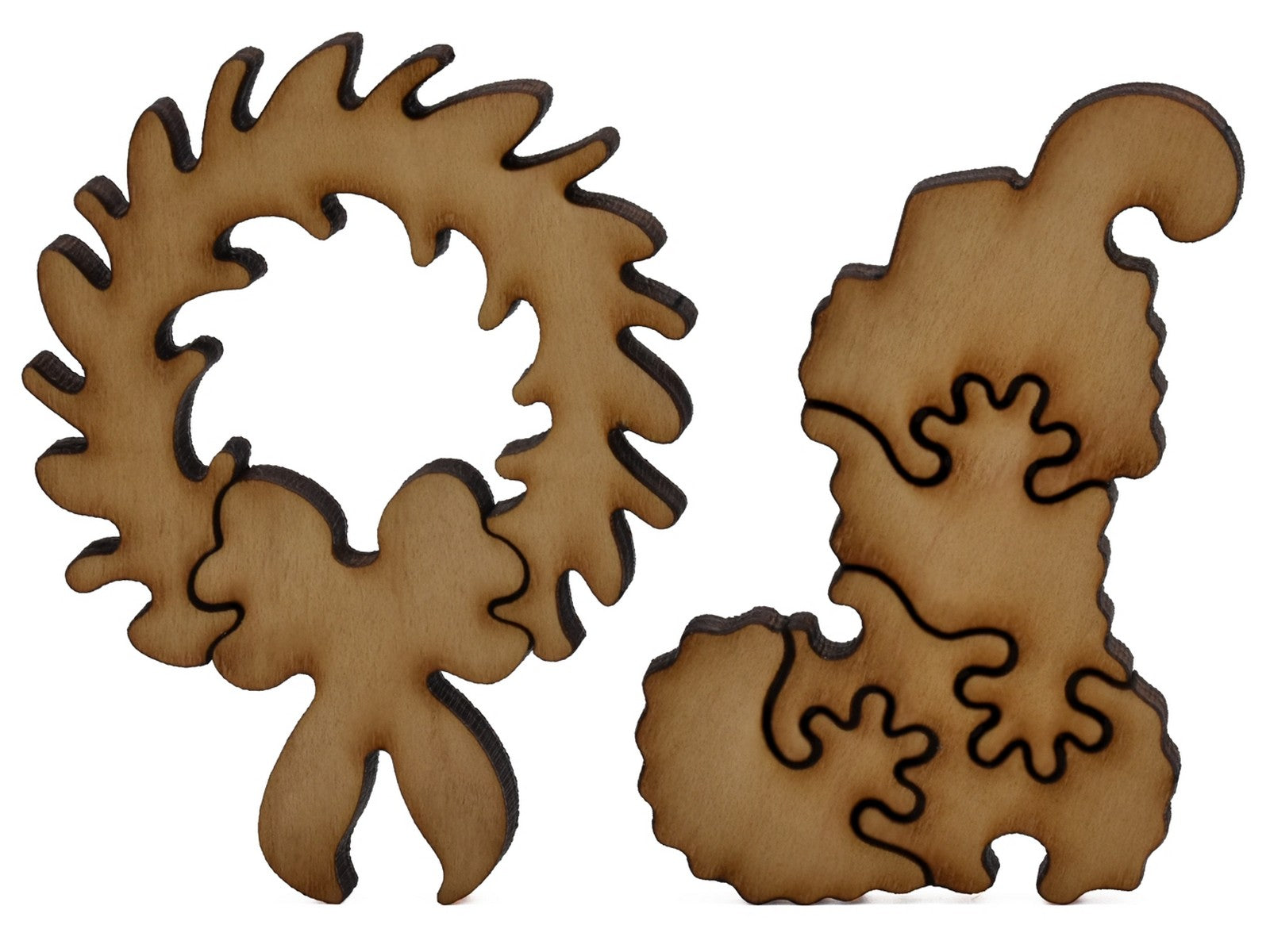 A closeup of pieces shaped like a wreath and a stocking.