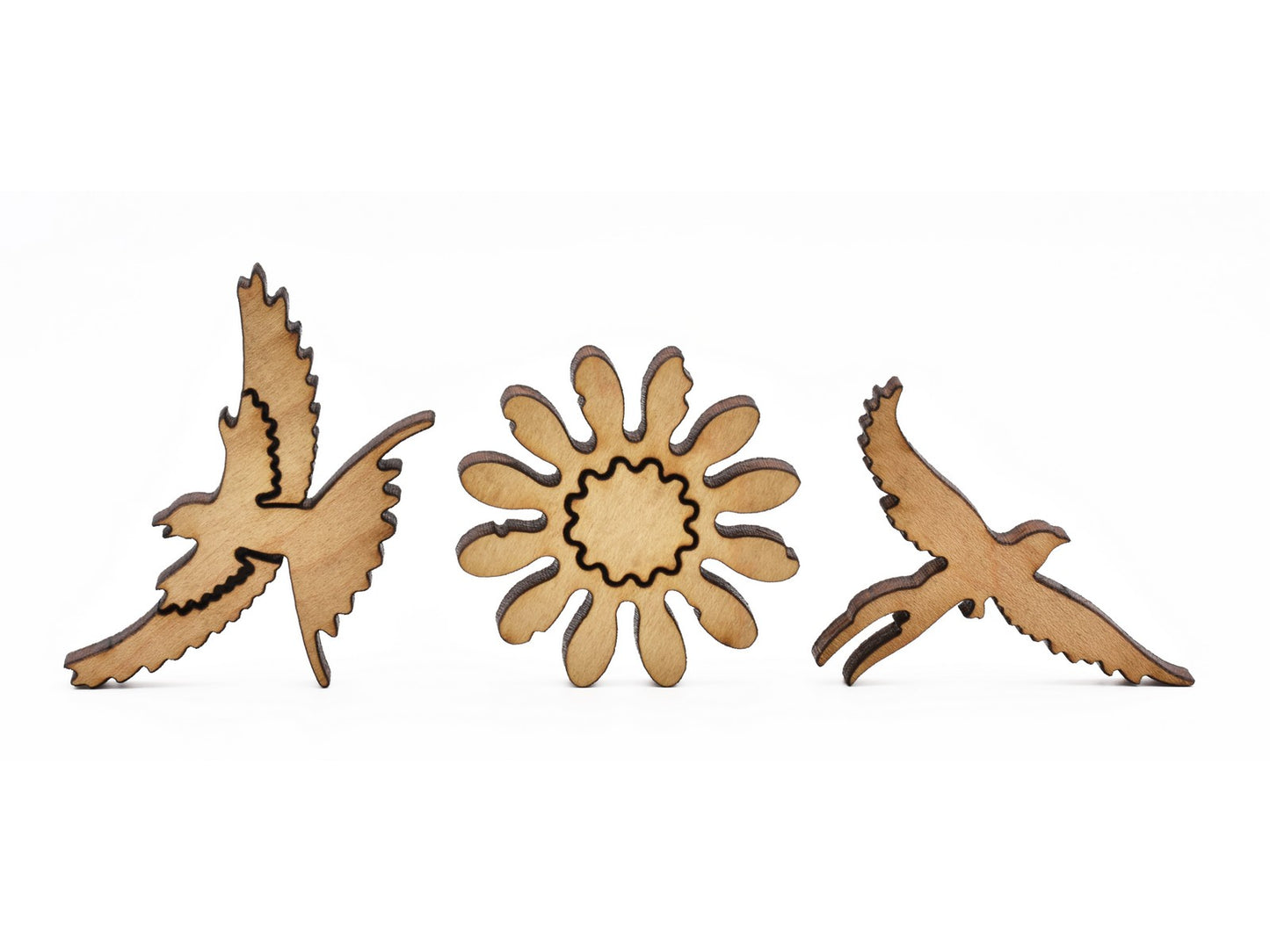 A closeup of pieces in the shape of birds and a flower.