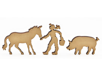 A closeup of pieces in the shape of a horse, a person, and a pig. 