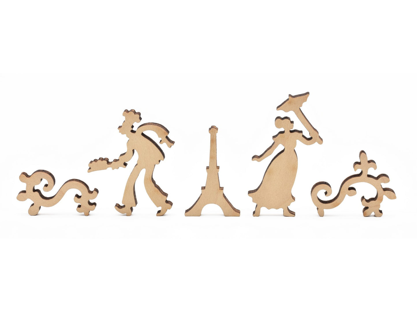 A closeup of pieces in the shape of the eiffel tower and people.