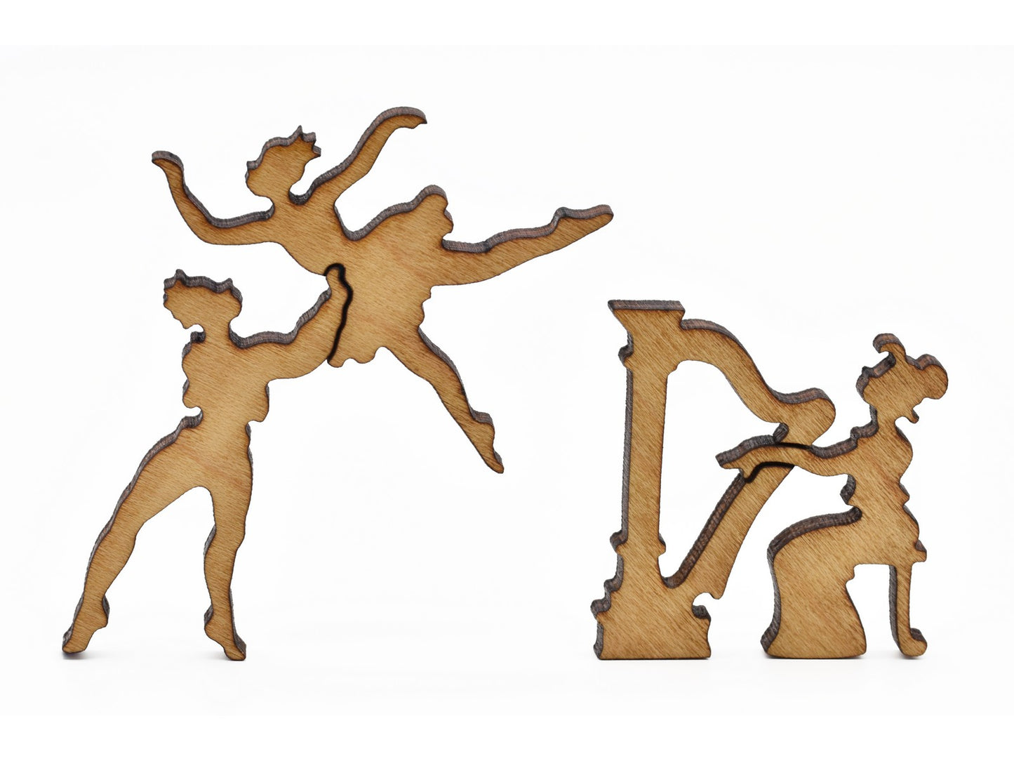 A closeup of pieces in the shape of a harpist and people dancing.