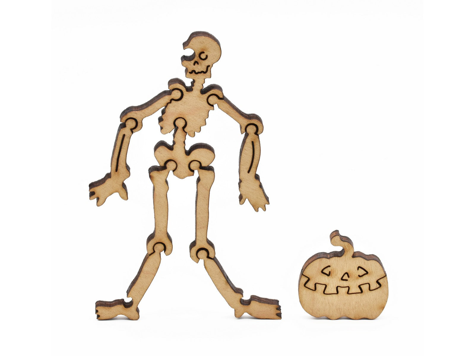 A closeup of pieces in the shape of a skeleton and a jack-o-lantern.