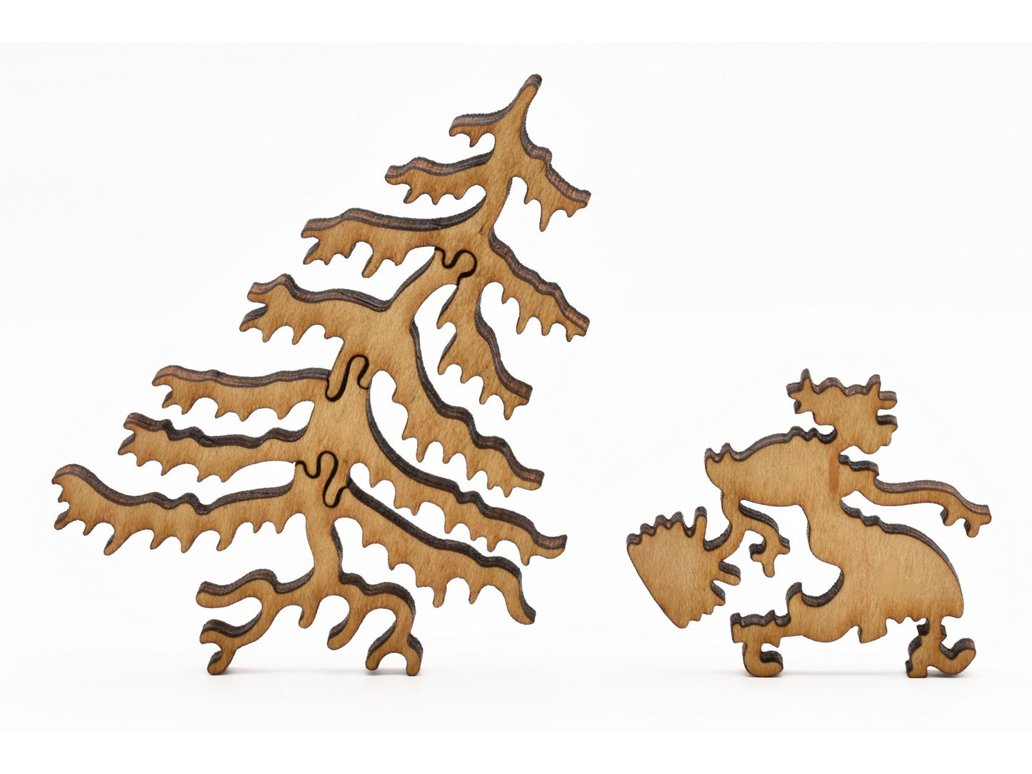 A closeup of pieces in the shape of an old woman and a tree.