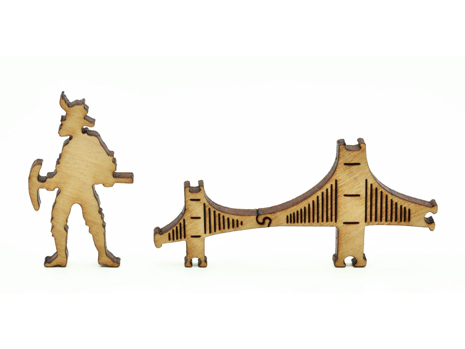 A closeup of pieces in the shape of a miner and the golden gate bridge.