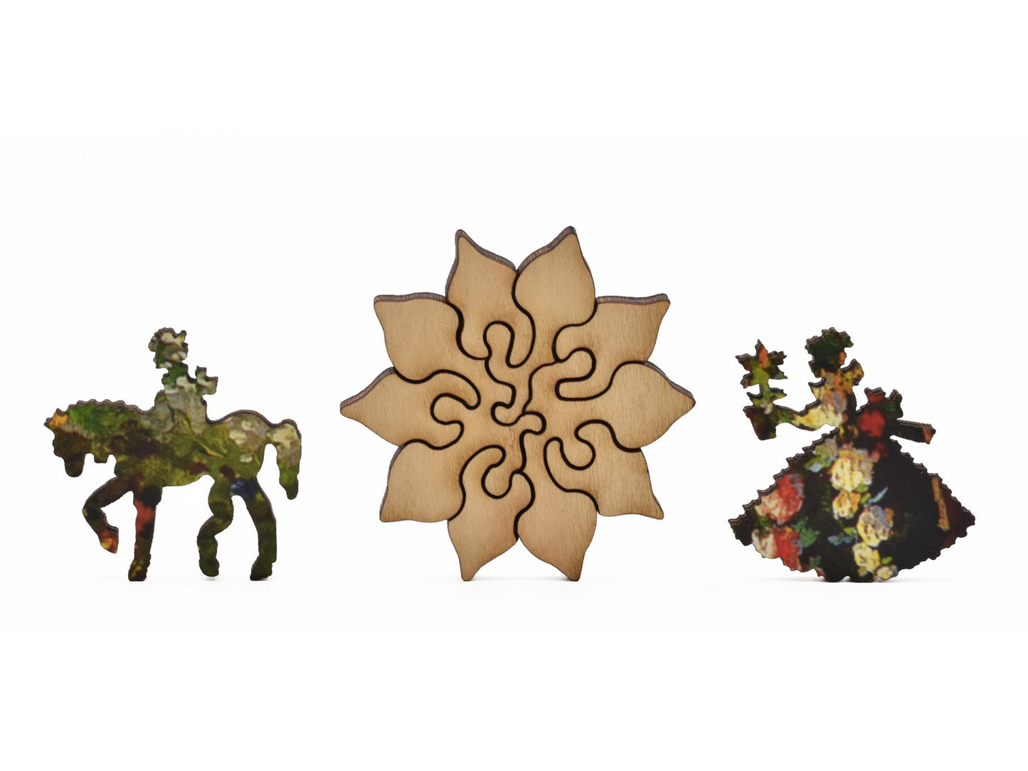 A closeup of pieces in the shape of a flower, a person riding a horse, and a person holding a flower.