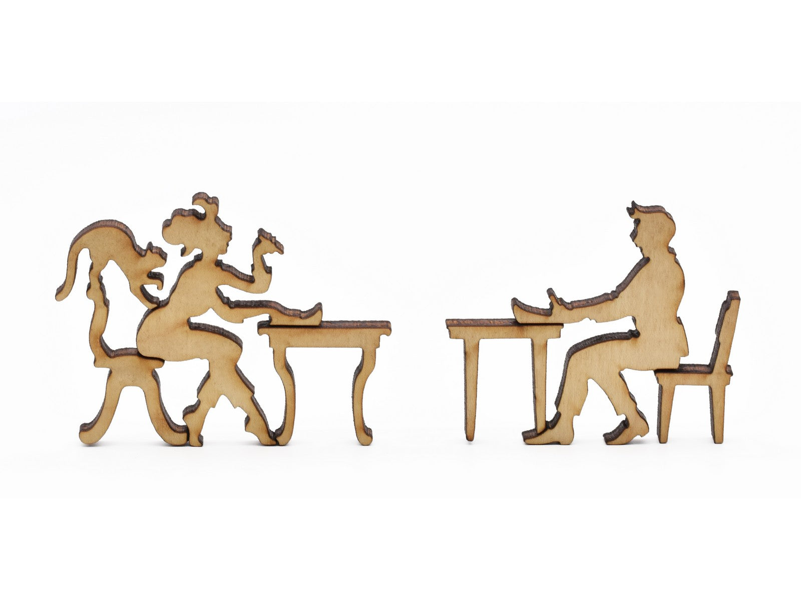 A closeup of pieces in the shape of two people at desks writing letters.