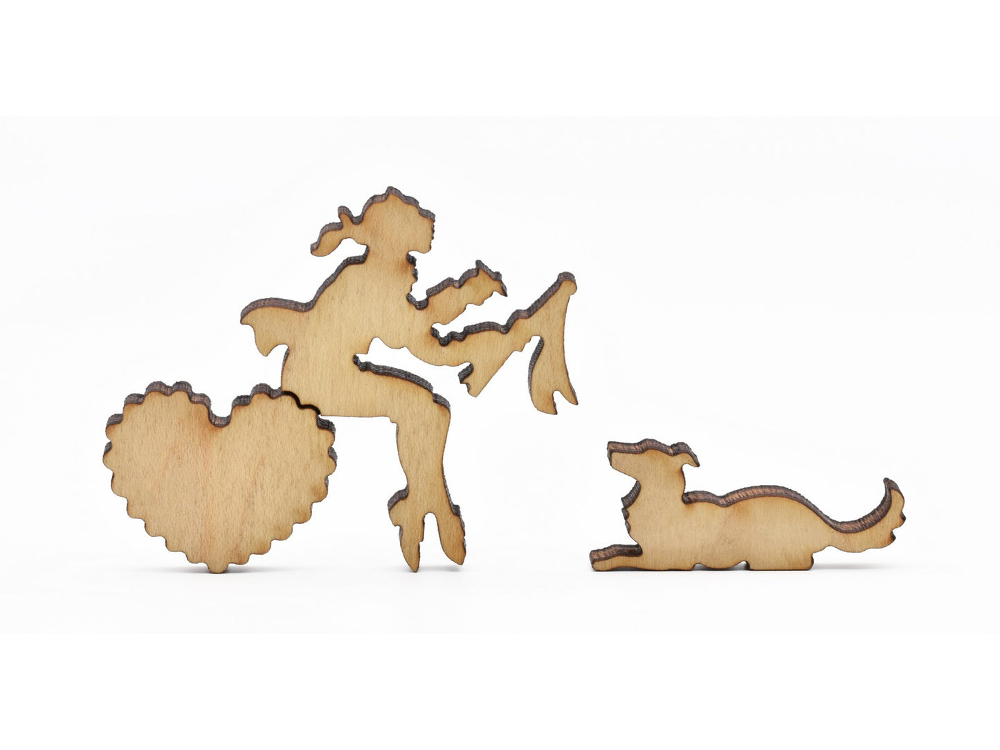 A closeup of pieces in the shape of a person writing a letter and a dog.