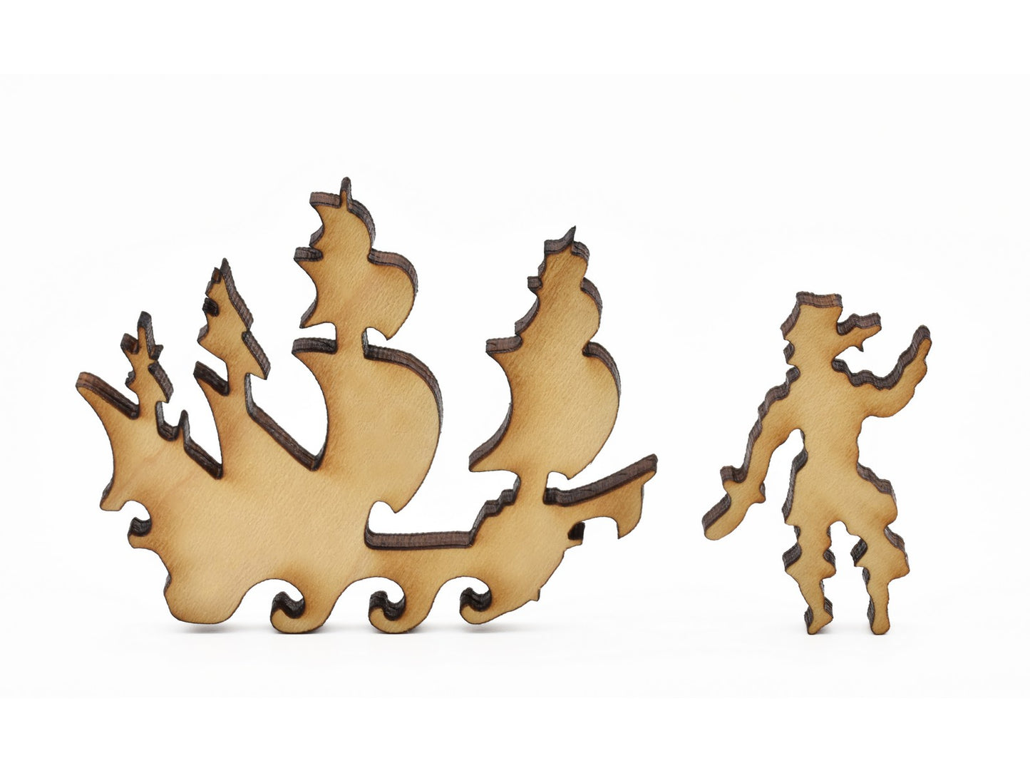 A closeup of pieces in the shape of a ship and a pirate.