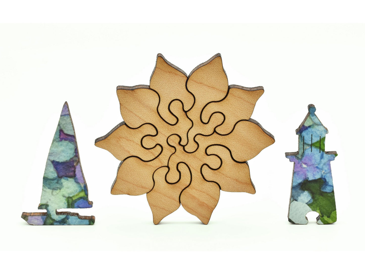 A closeup of pieces in the shape of a boat, a flower, and a lighthouse.