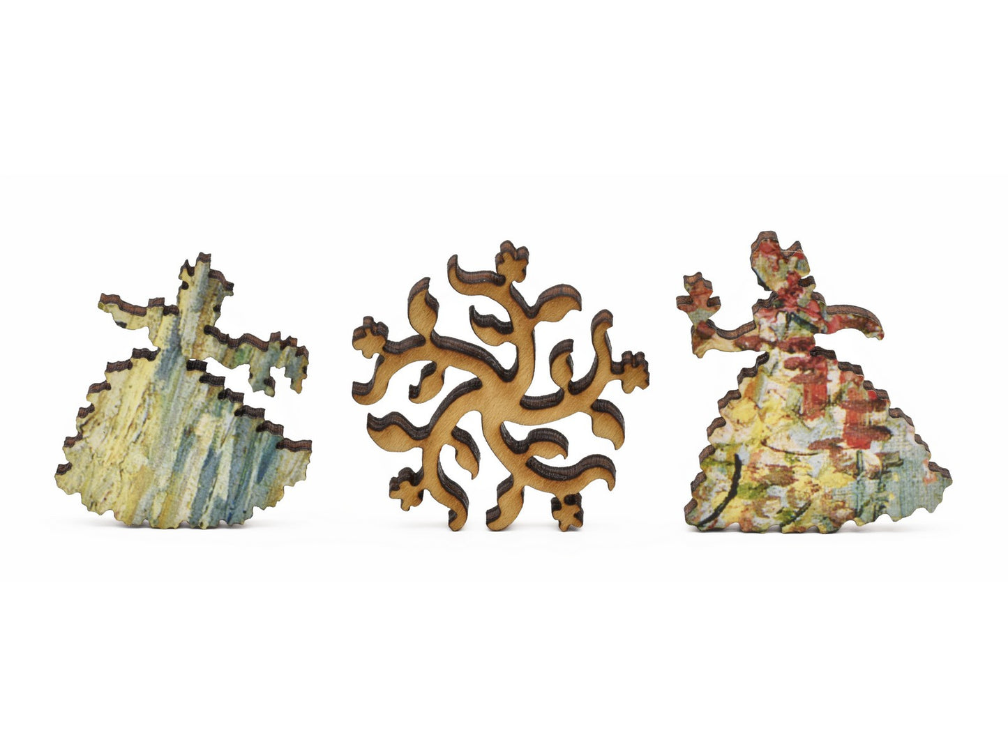 A closeup of pieces in the shape of two women and flowers.