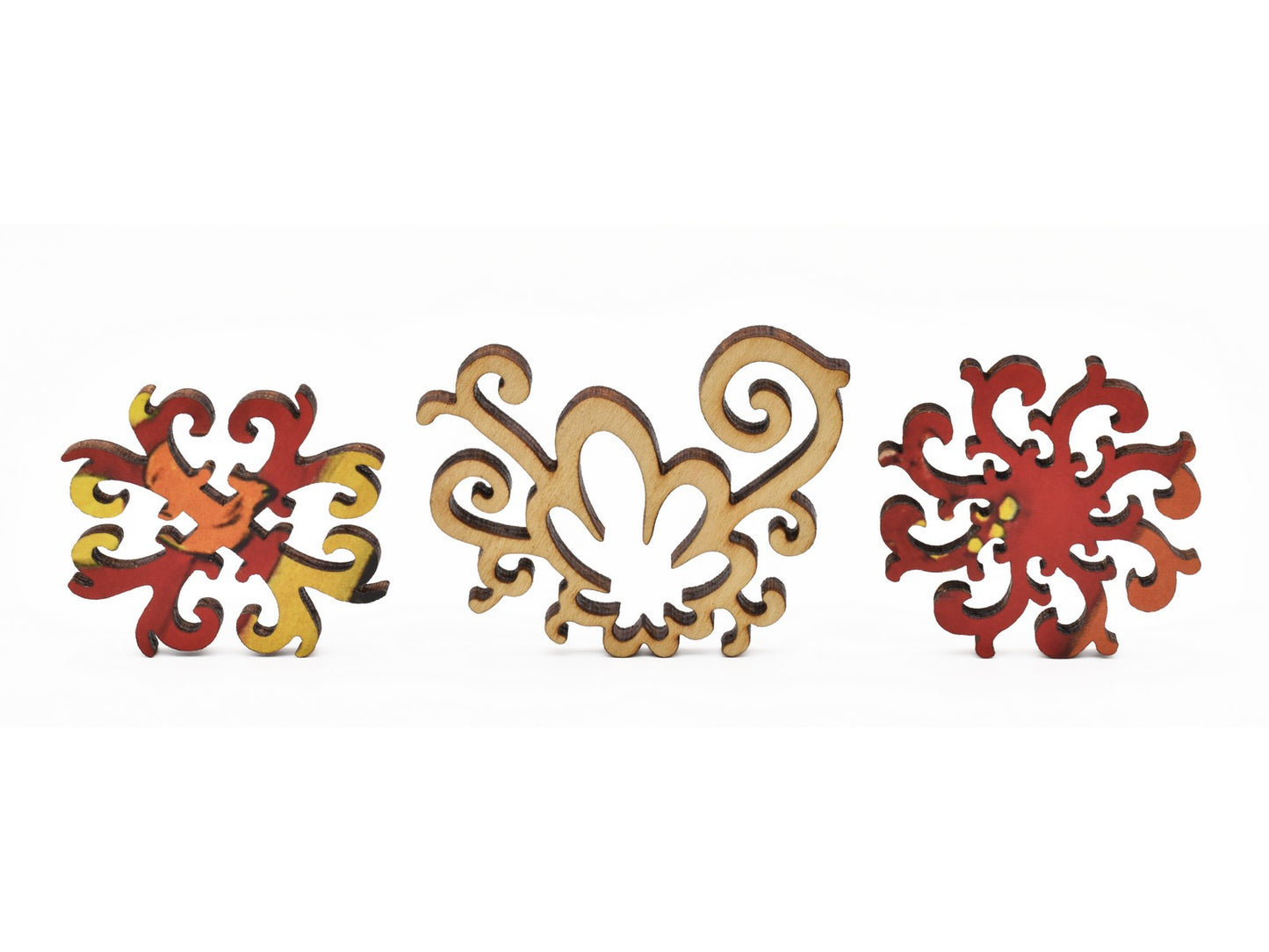 A closeup of pieces in the shape of abstract florals.