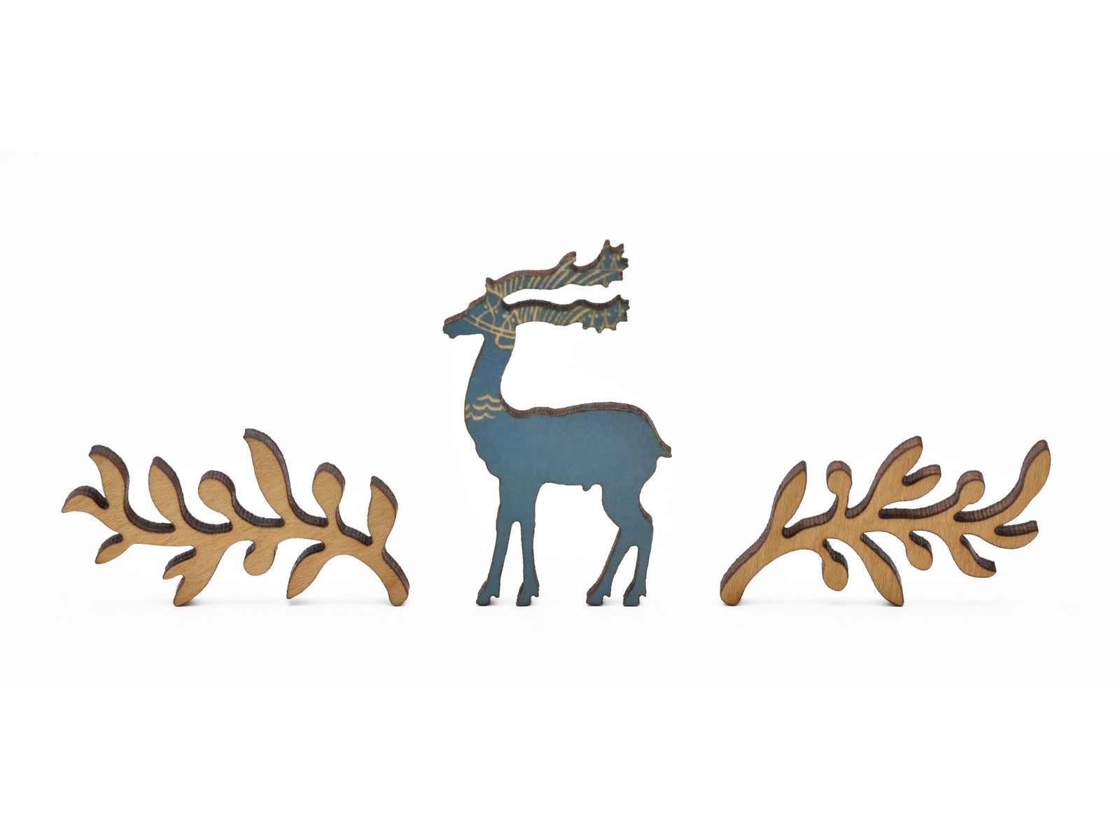 A closeup of pieces in the shape of a deer and olive branches.