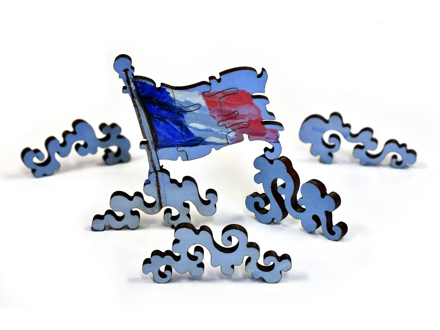 A closeup of pieces in the shape of a flag and clouds.