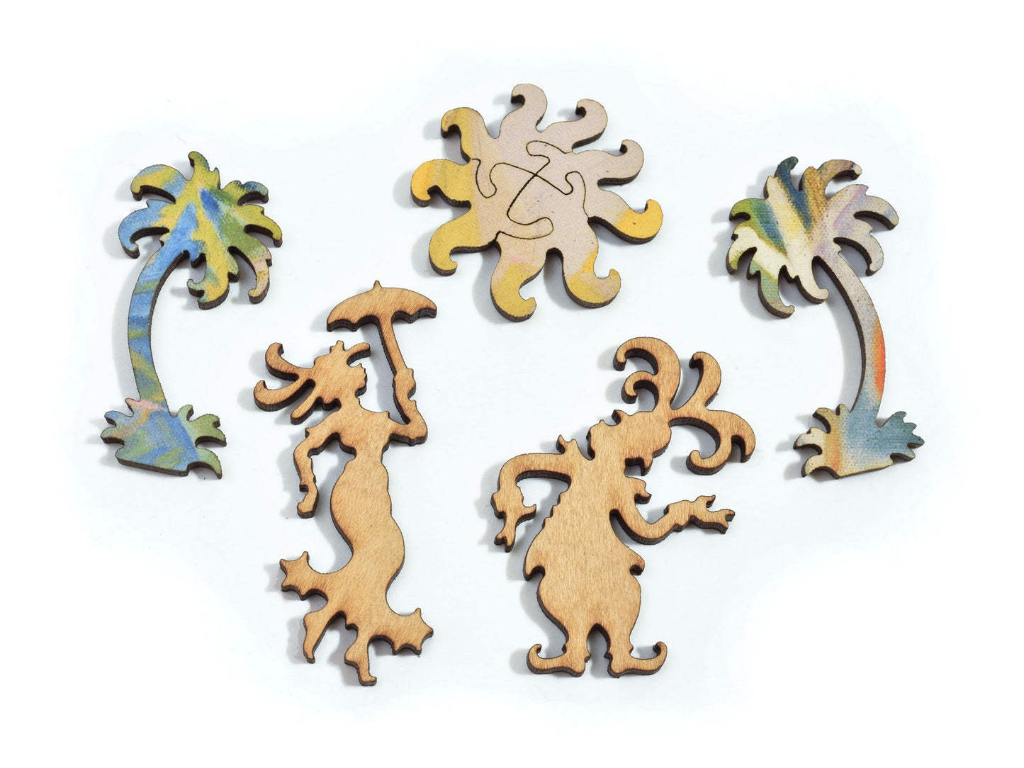 A closeup of pieces in the shape of the sun, two people and two palm trees.