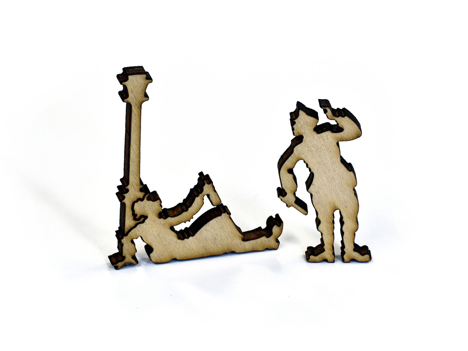 A closeup of pieces in the shape of two men and a lamppost.