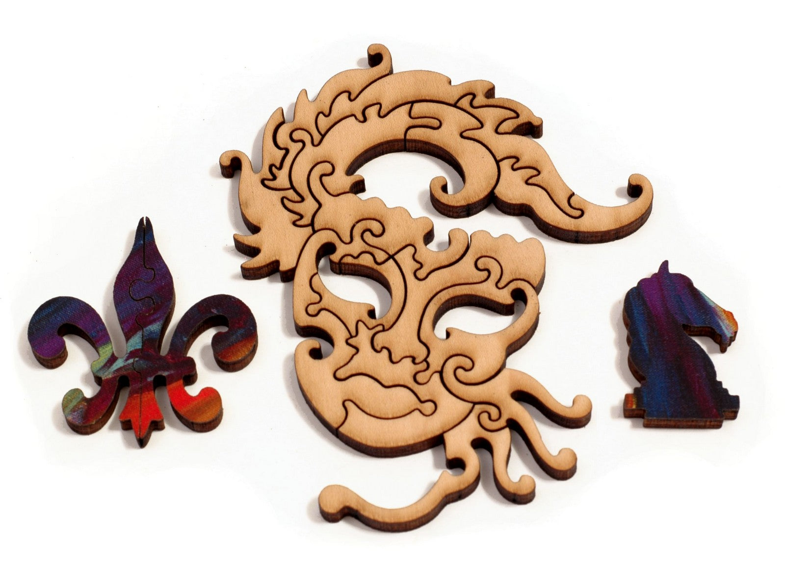 A closeup of pieces showing a costume mask, a fleur de lis, and a chess knight piece.