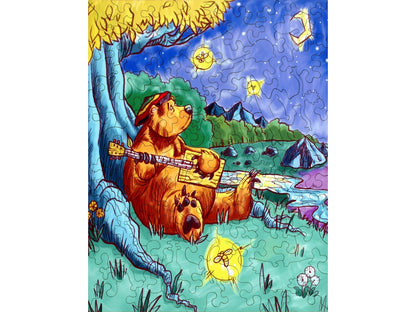 The front of the puzzle, Barry the Bear, which shows a bear sitting by a tree and playing a guitar while looking up into the night sky. 