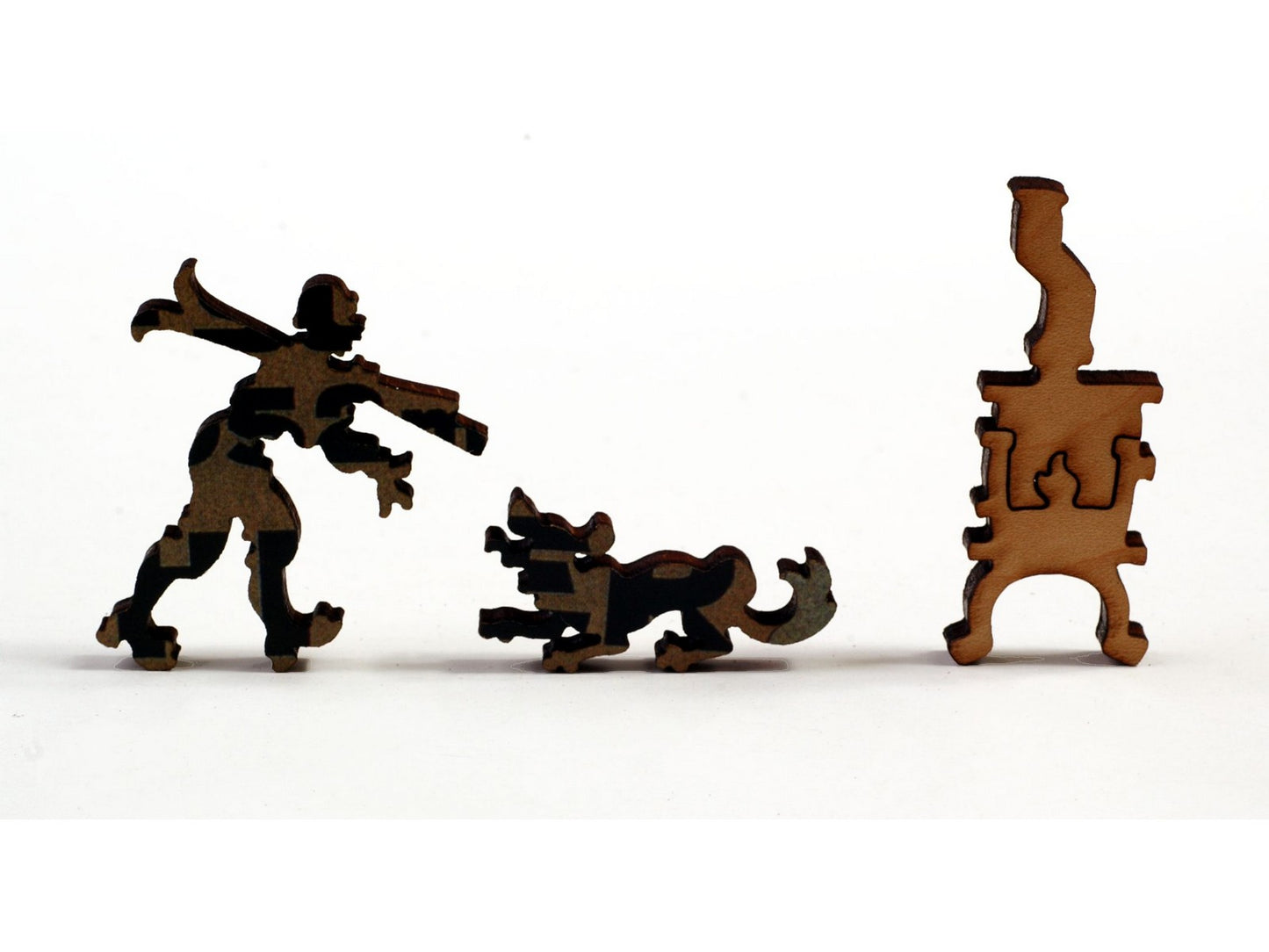 A closeup of pieces, in the shape of a man with skis, a dog, and a woodstove.