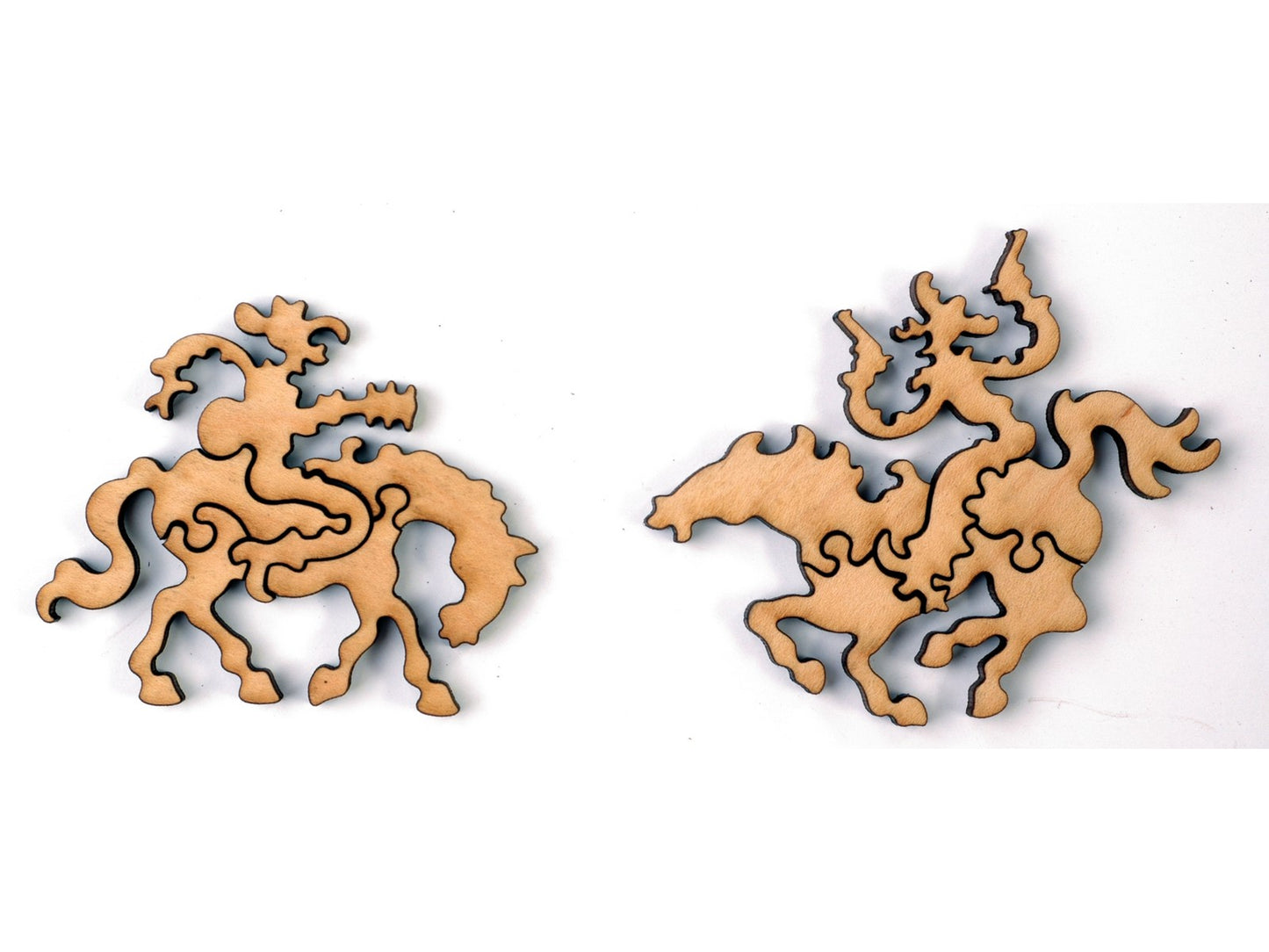 A closeup of pieces in the shape of cowboys riding horses.