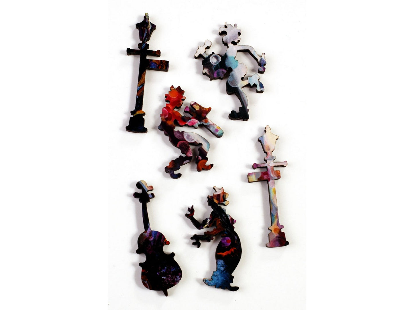A closeup of pieces in the shapes of three musicians and two lamp posts.