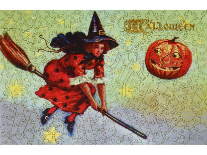 The front of the puzzle, Happy Halloween, which shows a witch flying on a broomstick.