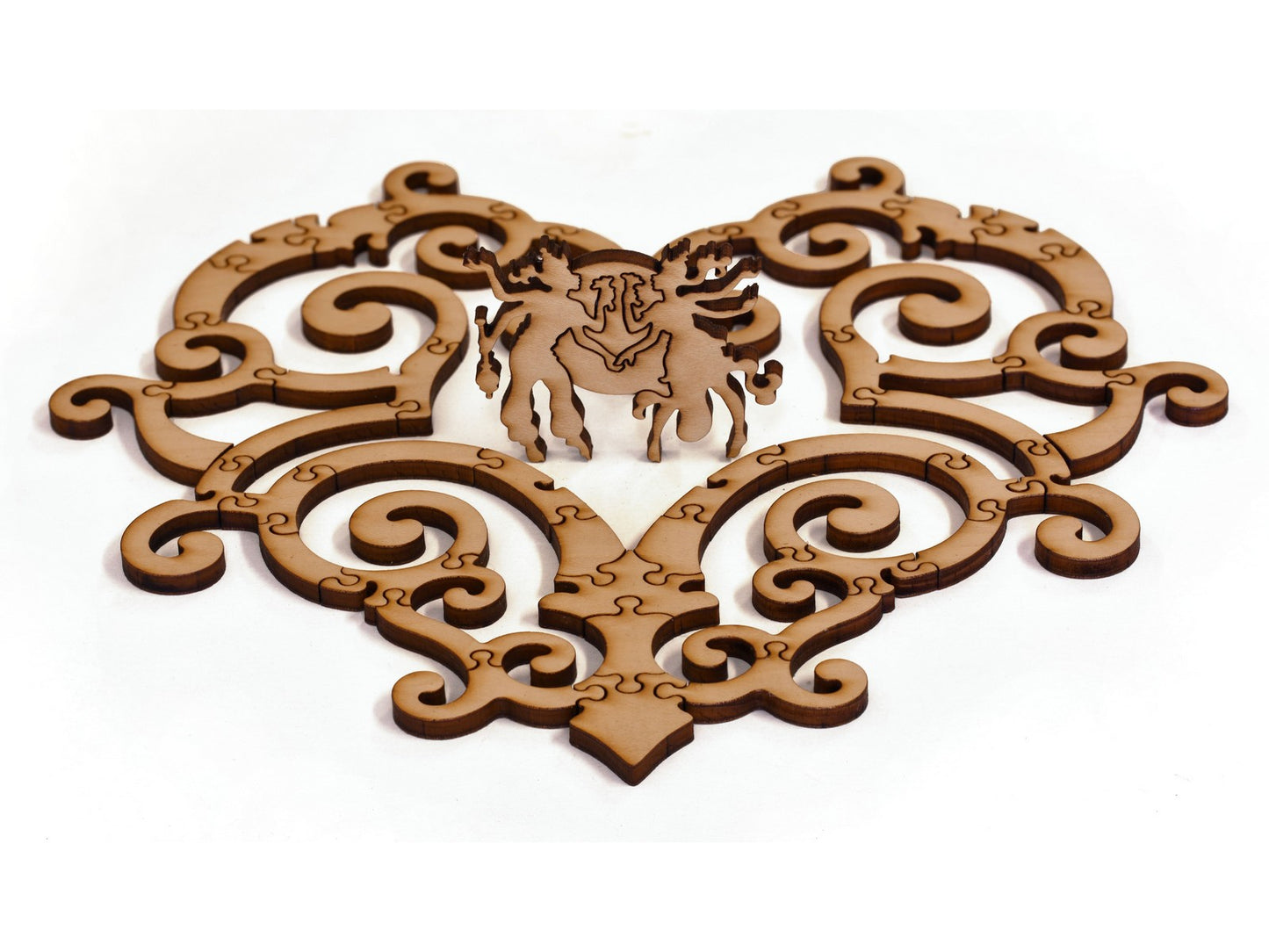 A closeup of pieces in the shape of an ornate heart with a couple in the middle.