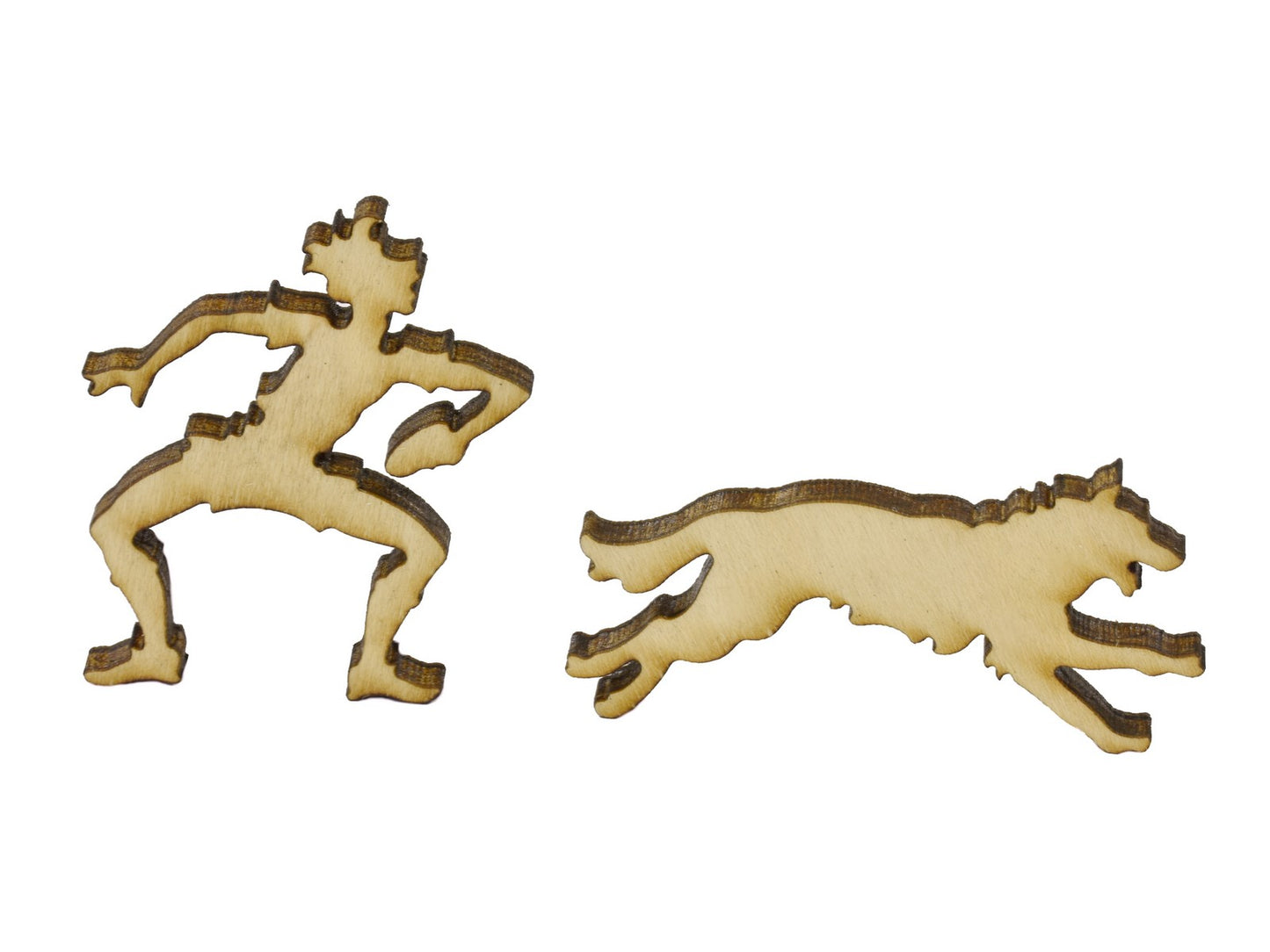 A closeup of pieces in the shape of a person playing frisbee with a dog.