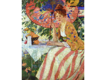 The front of the puzzle, Red-Headed Girl with Parasol, which shows a woman sitting at a table and holding a parasol.