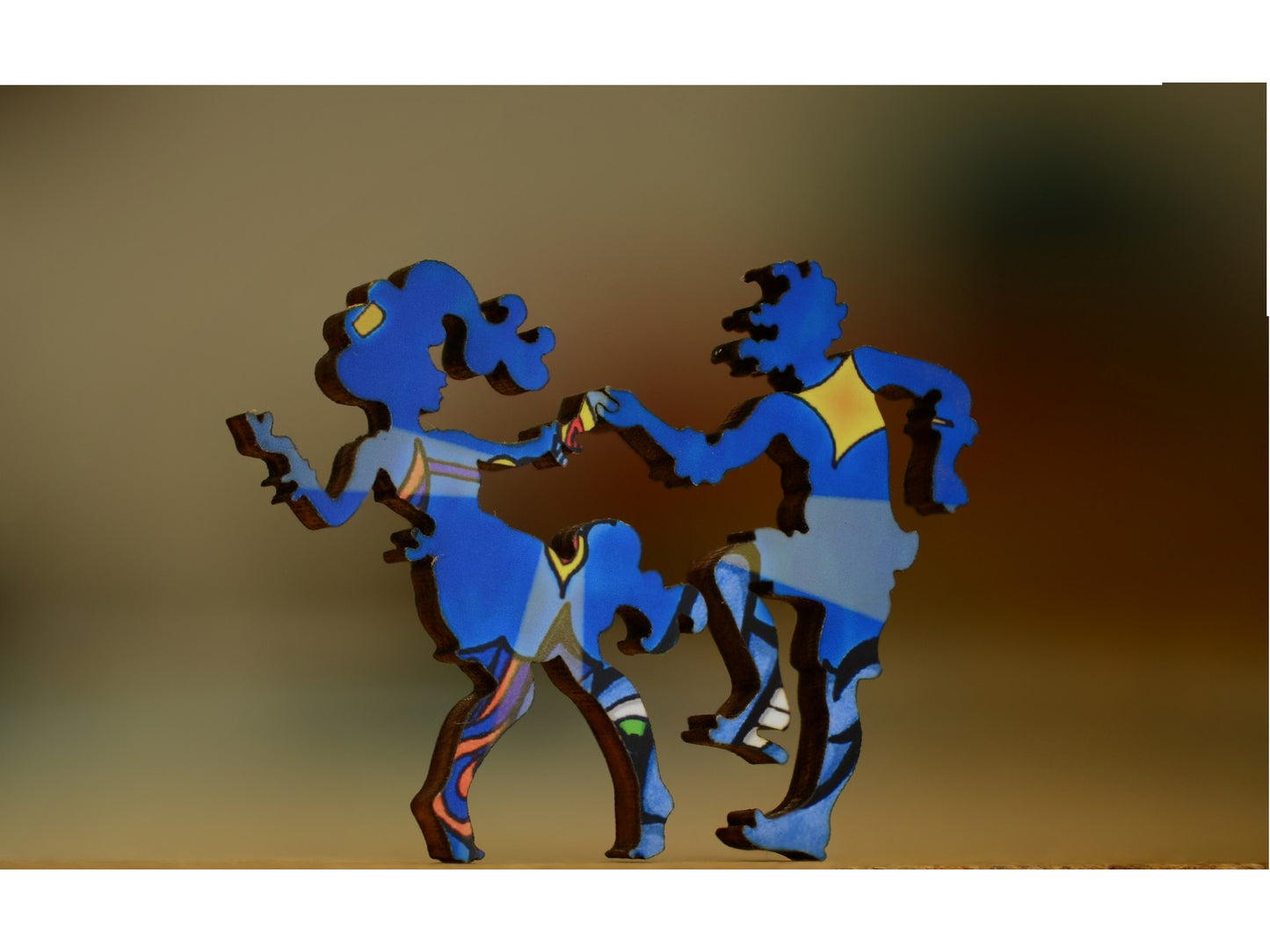 A closeup of pieces in the shape of a couple dancing.