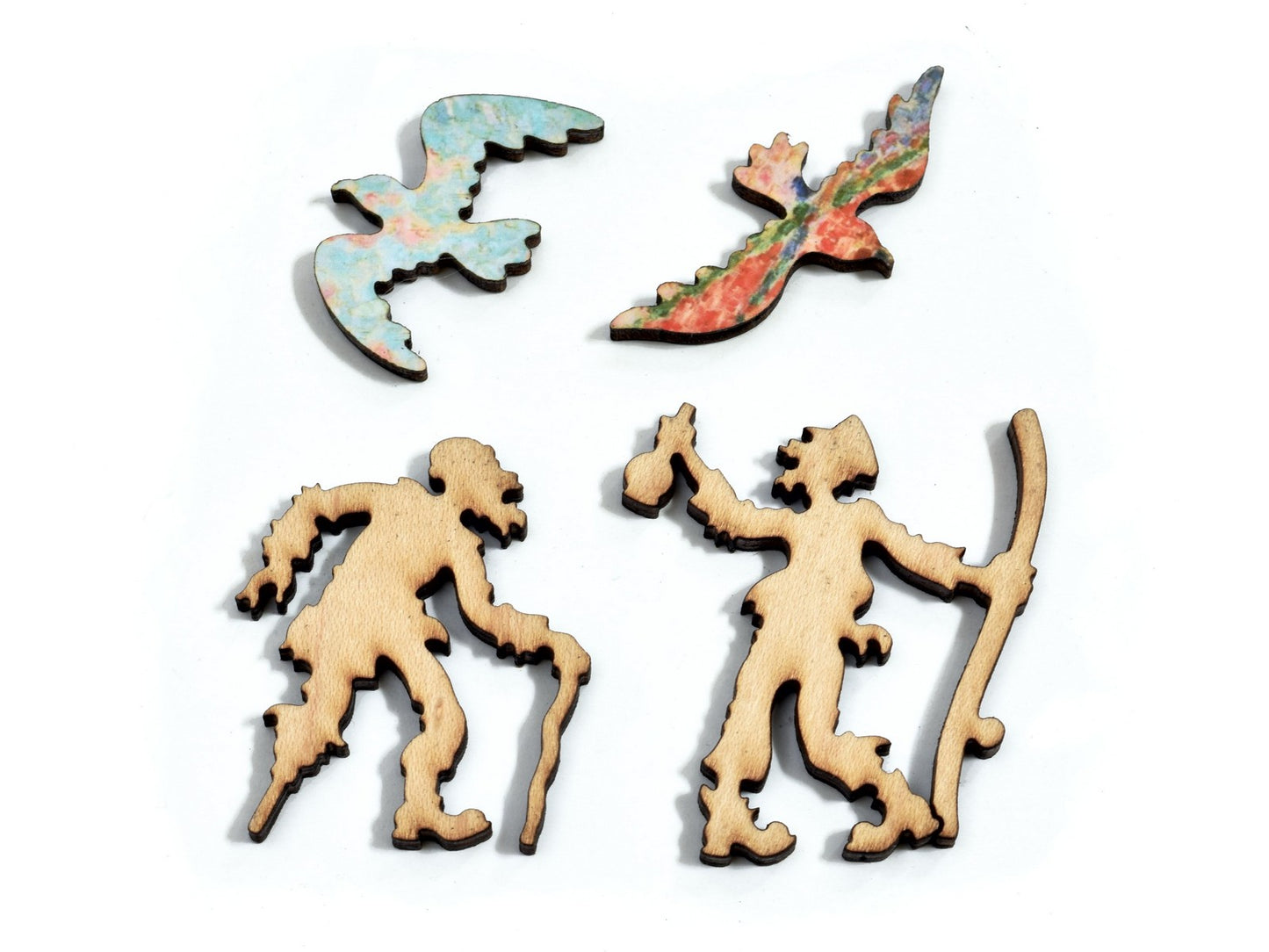 A closeup of pieces in the shape of people and seagulls.