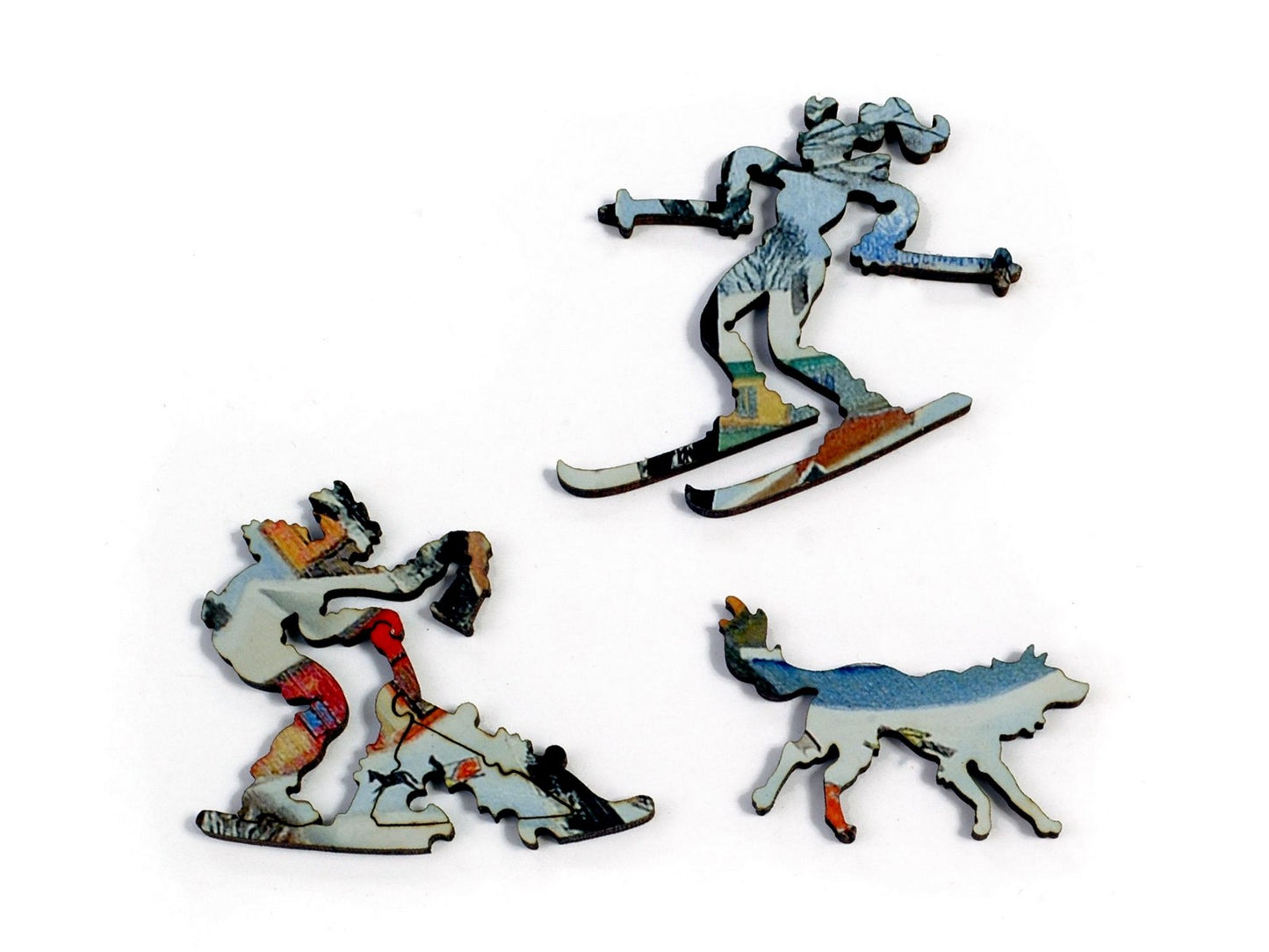 A closeup of pieces in the shape of a skier and a person on a dogsled.