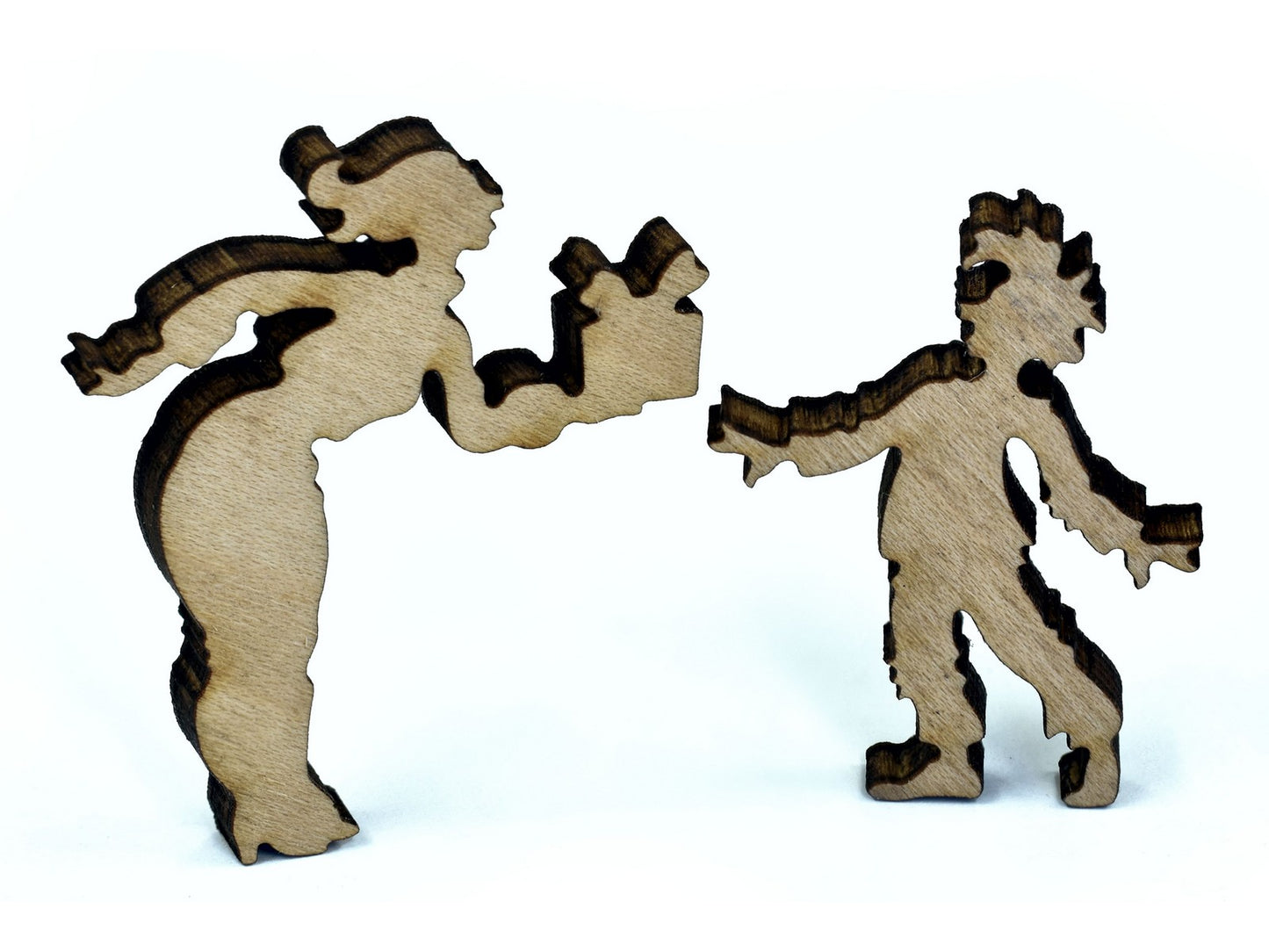 A closeup of pieces in the shape of a woman giving a child a present.