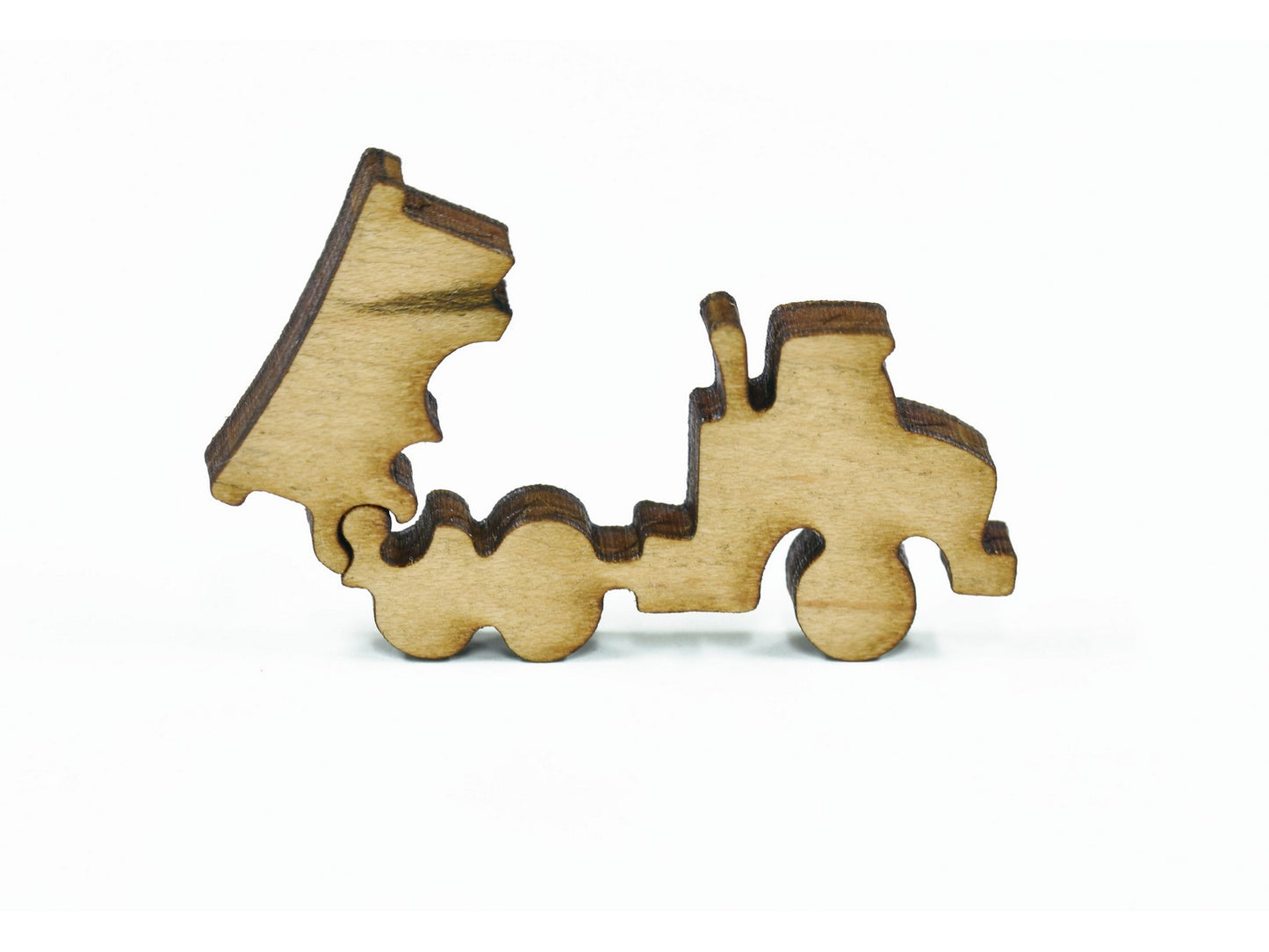 A closeup of pieces in the shape of a dump truck toy.
