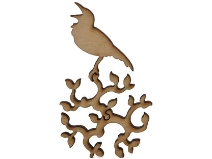 A closeup of pieces shaped like a bird sitting on a round branch.