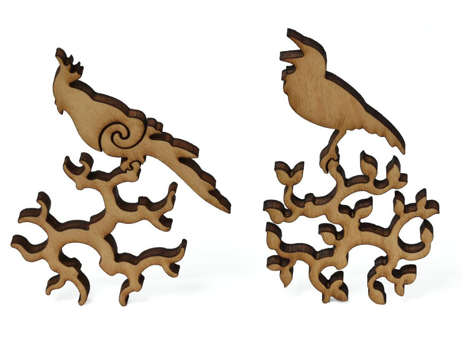 A closeup of pieces showing two birds sitting on branches.