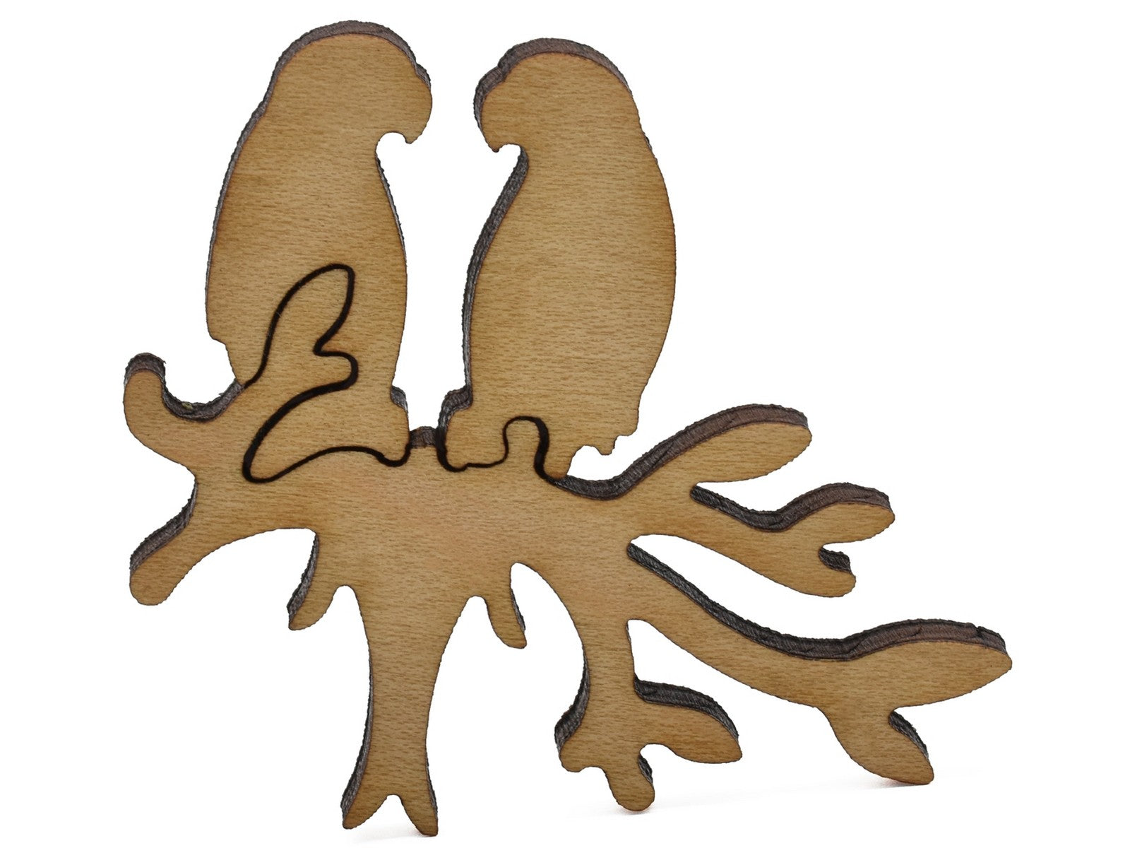 A closeup of pieces shaped like two birds on a branch.